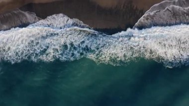 Aerial vertical of stormy waves of sea and beach