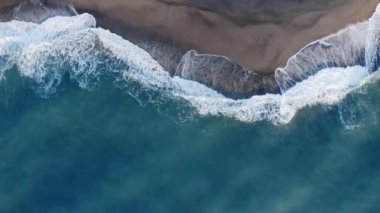Overhead of windy waves of the ocean at sunrise