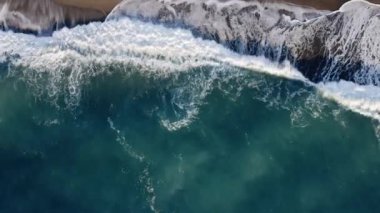 Aerial vertical of strong waves of ocean near the coast