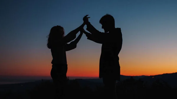 Silhouette di ragazzo e ragazza si tengono in mano — Foto Stock