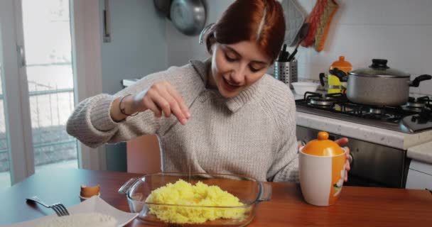 Chica está poniendo sal en hervido y puré de papas en la mesa en casa — Vídeo de stock