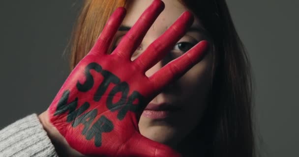 Fille rebelles contre le système et refuse la guerre en peignant sa main rouge — Video