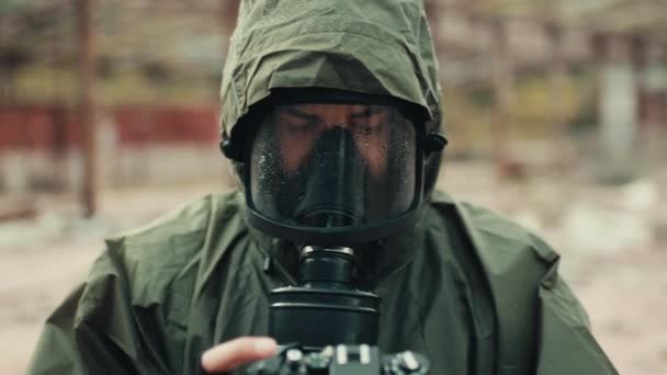 Militar con máscara de gas y fotografías de cámara la destrucción de la bomba — Vídeos de Stock