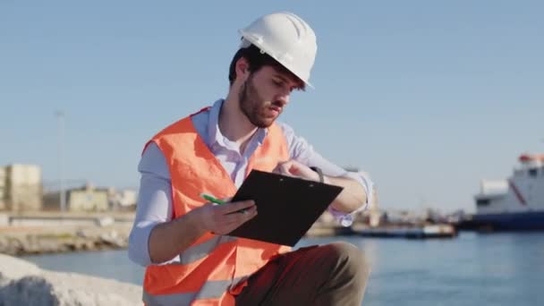 Naval engineer boy inspection the port in a city near the ocean — Stock Video