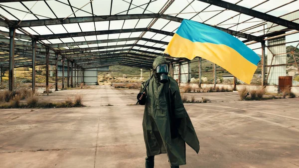 Prajurit bertopeng gas mengibarkan bendera Ukraina di gudang perang. — Stok Foto