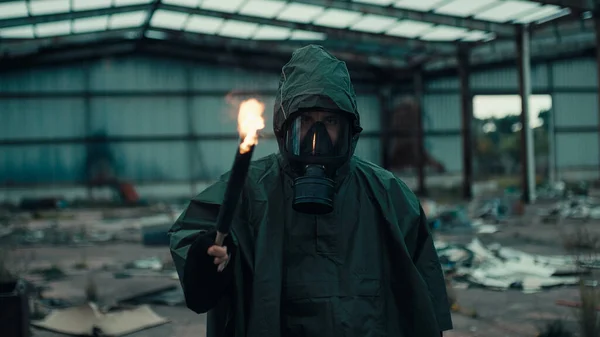 Soldat man med gasmask i en förstörd byggnad av krig med fackla — Stockfoto