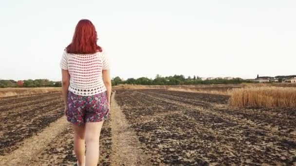 Young Farmer Woman Walks Arid Burnt Field Wheat Handheld Shoot — Stock video