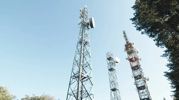 Telecommunications engineer turns to the radio antennas. Handheld shoot.