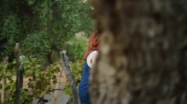 Girl walks through the vineyards to check the quality of the grapes for the harvest