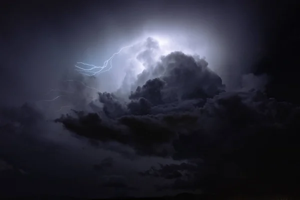 Lightning storm in the clouds in the night sky. Static shoot