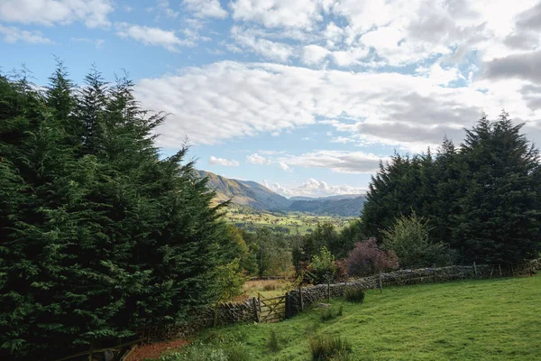 Mountains and dry stone wall with gate in Cumbria, England, United Kingdom