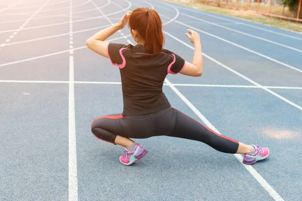Young Woman Runner Stretching Legs Run Workout Concept Stock Picture