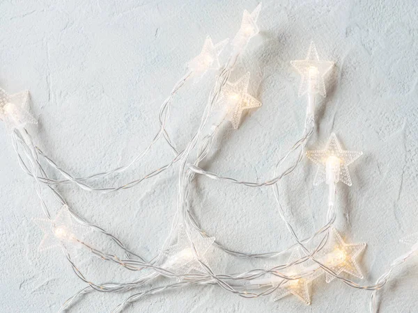 Light gray background with star shape Christmas lights string