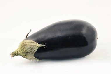 black eggplant lying on its side on a white background