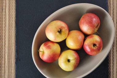 ripe red apples in a dish - top view
