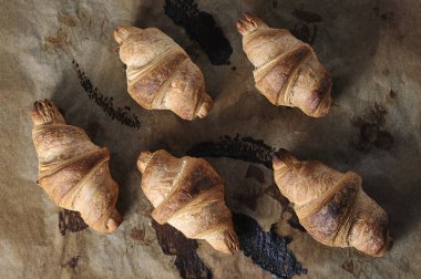 baked croissants on parchment paper - top view