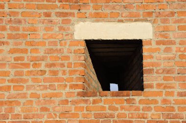 loophole in the fortress wall of the Kolomna Kremlin - red brick wall