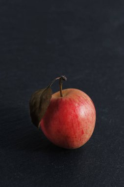 red ripe apple  on black board