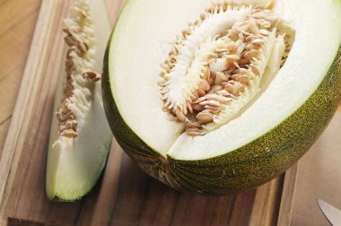 chopped melon, melon slice on craft wood background