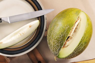 whole chopped melon on  craft paper background - top view flat view