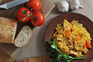 rice pilaf in a plate - a dish with meat, carrots and rice - top view flat layer