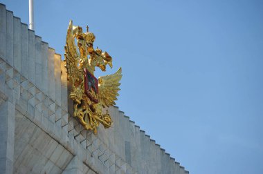 MOSCOW, RUSSIA - June 26, 2021: The golden coat of Arms of Russia on the State Kremlin Palace in Moscow