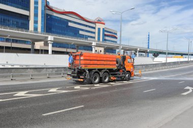 MOSCOW, RUSSIA - May 23, 2021: a cleaning machine pours water on the road in Moscow