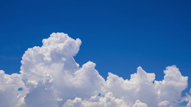 Cloudscape background of beautiful white cumulonimbus clouds on blue sky in sunny day