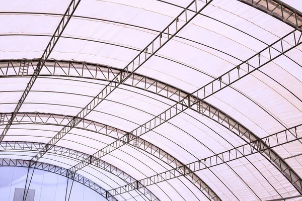 View from inside of metal roof structure with canvas of large dome event tent