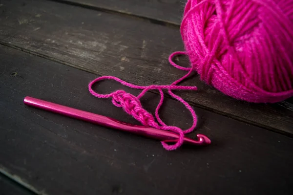 Pink Wool Ball Close Pink Crochet Hook Wooden Ground Handmade — Stockfoto
