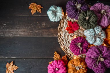 Koyu kahverengi ahşap zemin üzerinde ışık ve sonbahar yapraklı el yapımı balkabakları.