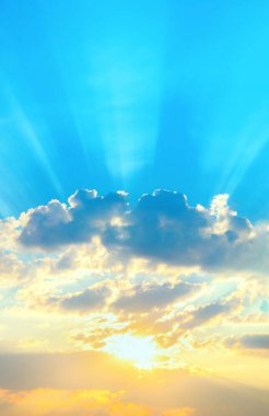 Sunrise sky with sun golden rays breaking through the dark clouds. Nature background. Hope concept.