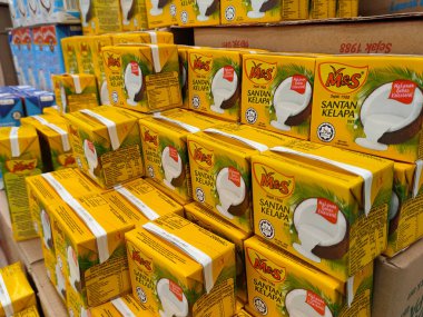 KUALA LUMPUR, MALAYSIA - 12 Haziran 2021: Ticari paketleme ve süpermarketlerde sergilenen işlenmiş hindistan cevizi sütü üzerine odaklanmış. Markaya göre sıralanmış ve fiyat etiketi var..