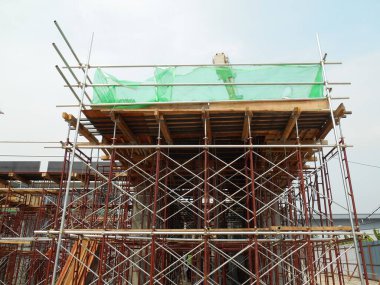 SELANGOR, MALAYSIA -APRIL 13, 2015: İnşaat alanındaki yapı çalışmalarını desteklemek için kullanılan geçici yapı iskelesi. Ayrıca işçiler için yürüme platformu olarak kullanılıyor.. 