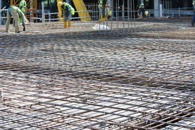 SELANGOR, MALAYSIA -MAY 13, 2016: Hot rolled deformed steel bars or steel reinforcement bars used at the construction site to strengthen concrete. It is shaped to follow the engineer's design. clipart