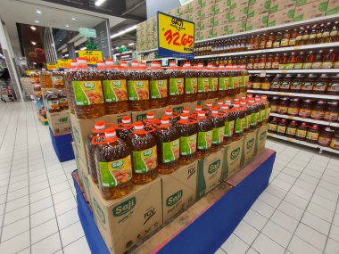JOHOR, MALAYSIA -14 Nisan 2021: Süpermarkette satılmak üzere işlenmiş palmiye tohumundan yapılan pişirme yağına odaklandı. Müşterinin seçmesini kolaylaştırmak için markaya göre sıralanır. 