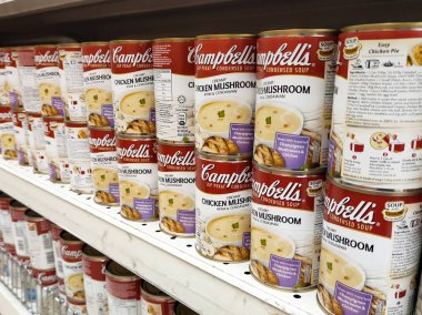 PENANG, MALAYSIA - JULY 13, 2021: Selected focused on mushroom soup in various flavors packed in the commercial packaging. Displayed for customers on the sales shelf. Tagged with the price tag. 