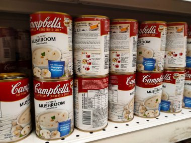 PENANG, MALAYSIA - JULY 13, 2021: Selected focused on mushroom soup in various flavors packed in the commercial packaging. Displayed for customers on the sales shelf. Tagged with the price tag. 