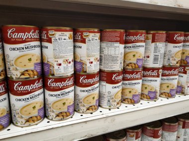 PENANG, MALAYSIA - JULY 13, 2021: Selected focused on mushroom soup in various flavors packed in the commercial packaging. Displayed for customers on the sales shelf. Tagged with the price tag. 