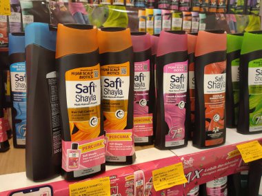 PENANG, MALAYSIA -JUNE 10, 2021: Selected focused on the hair shampoo in plastic bottle packaging, on display for sale on the shelves in the supermarket. Tagged with the price tag.