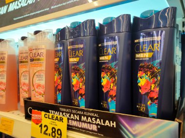 PENANG, MALAYSIA -JUNE 10, 2021: Selected focused on the hair shampoo in plastic bottle packaging, on display for sale on the shelves in the supermarket. Tagged with the price tag.