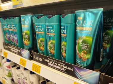 PENANG, MALAYSIA -JUNE 10, 2021: Selected focused on the hair shampoo in plastic bottle packaging, on display for sale on the shelves in the supermarket. Tagged with the price tag.