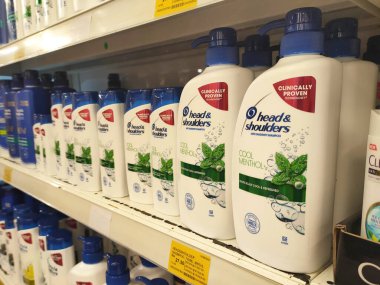 PENANG, MALAYSIA -JUNE 10, 2021: Selected focused on the hair shampoo in plastic bottle packaging, on display for sale on the shelves in the supermarket. Tagged with the price tag.