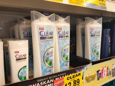 PENANG, MALAYSIA -JUNE 10, 2021: Selected focused on the hair shampoo in plastic bottle packaging, on display for sale on the shelves in the supermarket. Tagged with the price tag.