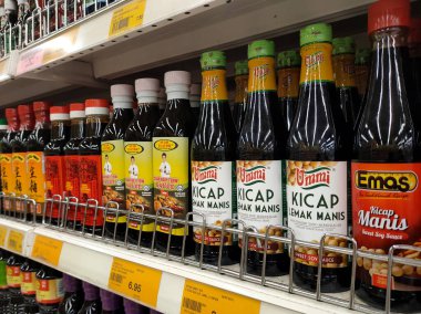 PENANG, MALAYSIA -5 Mart 2021: Pişirme malzemesi olarak kullanılan soya sosunun çeşitli türleri süpermarketlerde satılıyor. Markayla sınıflandırıldı ve fiyat etiketi ile etiketlendi..