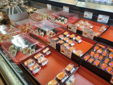 SEREMBAN, MALAYSIA - 29 HAZİRAN 2022: Soğutucuda sergilenmek üzere suşi sergilenmeye odaklanmış. Tepside türüne göre ayrılır ve müşterilerin rahatlığı için bir fiyat etiketi yerleştirilir.