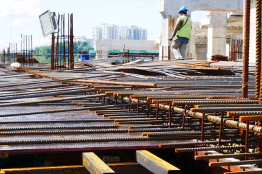 PENANG, MALAYSIA - 4 Mart 2020: döşeme plakaları bir inşaat sahasında yapım aşamasında. İşçiler, beton dökülmeden önce keresteye çelik takviyesi yapmakla meşguldü..