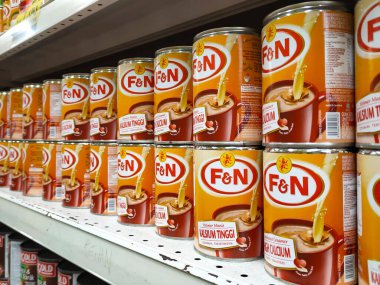 SELANGOR, MALAYSIA -4 Nisan 2022: tatlandırılmış krema ve buharlaştırılmış süt kutularda paketlendi. Süpermarketin içindeki rafta satılık. Ana bileşen palmiye yağı tohumlarından yapılır..