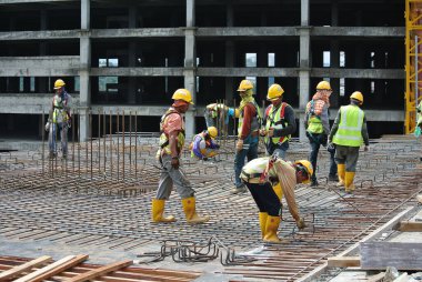 MALACCA, MALAYSIA - SEPTEMBER 28, 2016: Malacca, Malezya 'daki inşaat alanında döşeme destek barı üreten inşaat işçileri.  