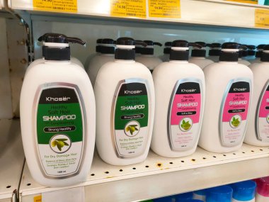 SELANGOR, MALAYSIA -APRIL 6, 2022: Selected focused on the hair shampoo in plastic bottle packaging, on display for sale on the shelves in the supermarket. Tagged with the price tag.
